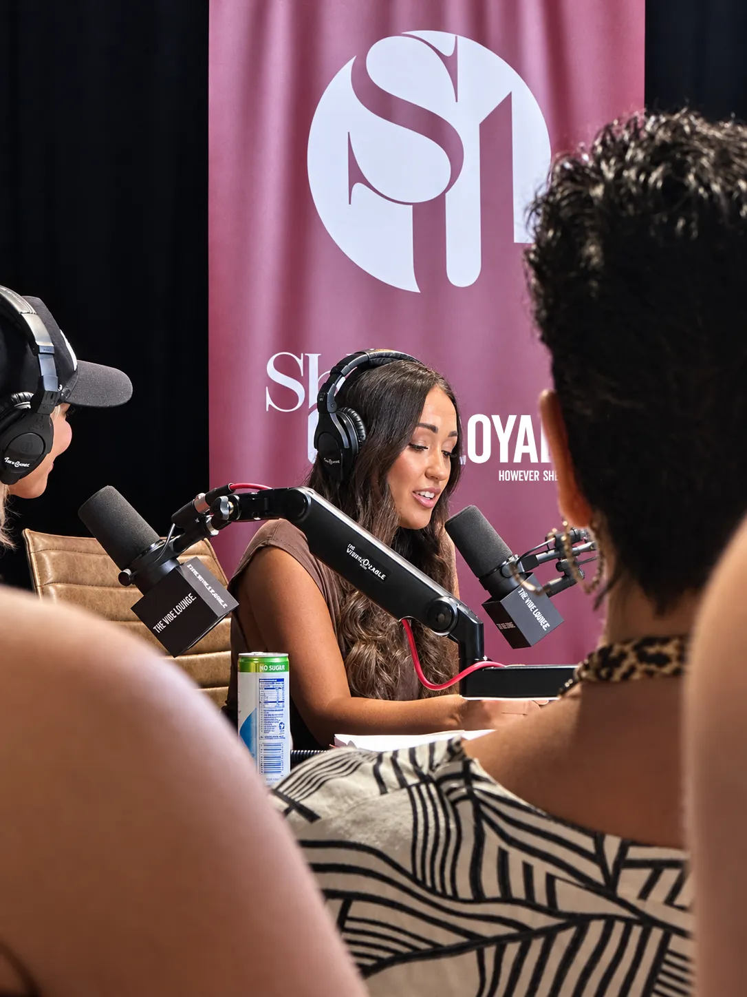 She's Unemployable podcast recording with a branded backdrop
