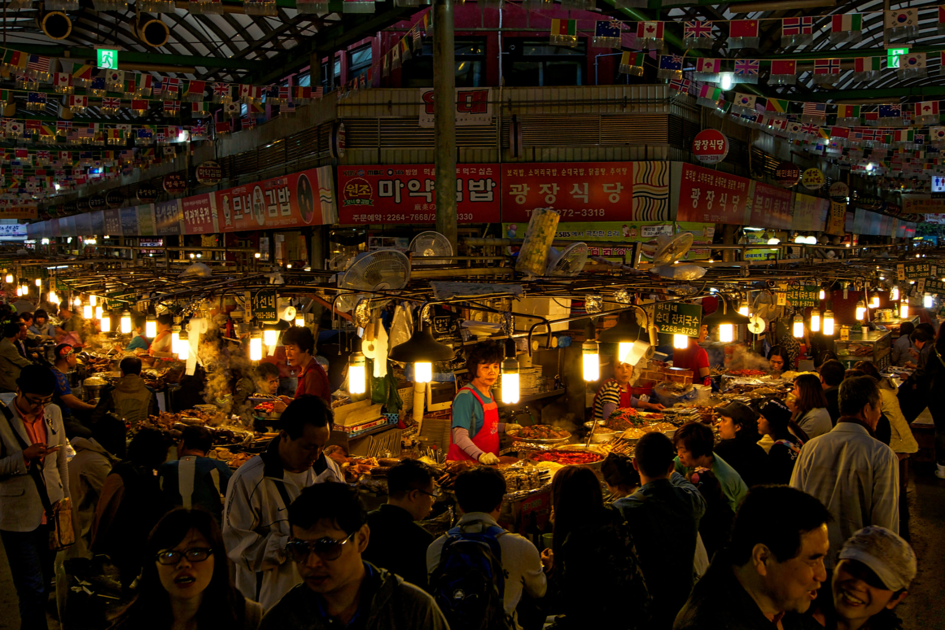 A crowded market with many stalls competing for attention