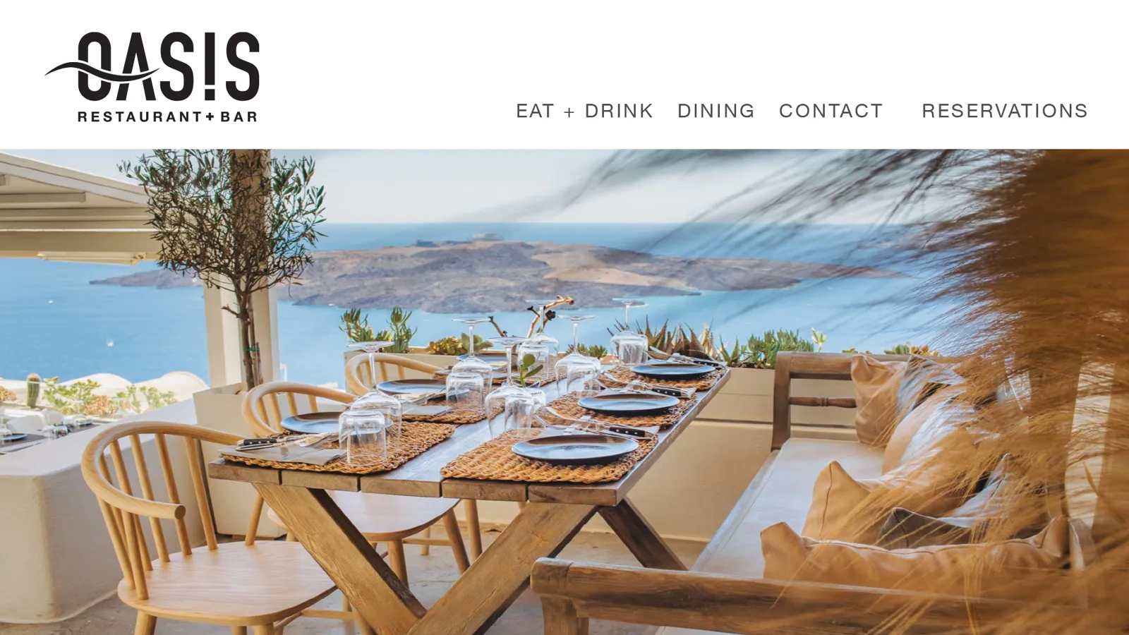 Oasis website homepage with a terrace dining table overlooking the sea