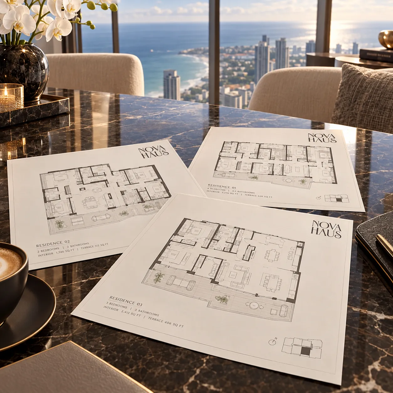 Nova Haus residence floor plans spread on a marble table beside a coffee, with the coastline visible through the window